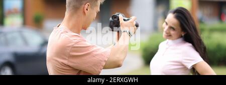 Männlicher Fotograf fotografiert weibliches Model auf der Straße. Stockfoto