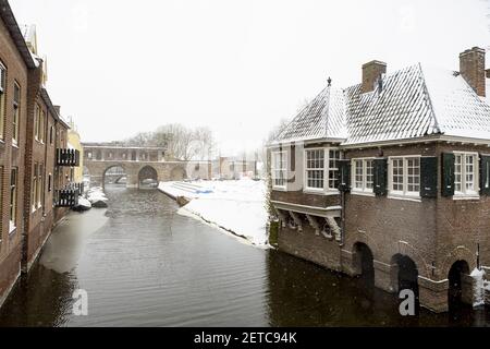 Mittelalterliche Hansestadt während eines Schneesturms zeigt Reste der Berkelpoort Stadtmauer mit dem weißen Niederschlag im Vordergrund Stockfoto