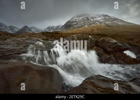 Langer seidiger Wasserfall zwischen Steinen und Felsen. Reisen, Tourismus, Abenteuer, Bergsteiger Konzept- Fairy Pools - Skye Island - Schottland - UK Stockfoto