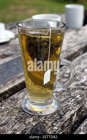 Grüner Tee in einem hohen Glas auf einem Holztisch Stockfoto