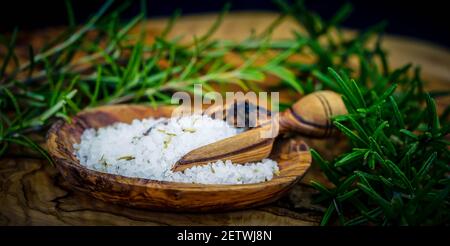 Meersalz und Rosmarinzweige auf Olivenholz Stockfoto