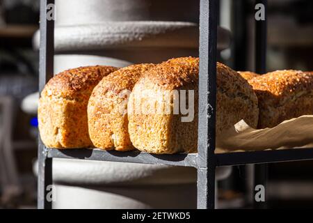 Frisch gebackenes Brot auf einem Regal in der Bäckerei. Gourmet-Brot zum Verkauf. Selektiver Fokus. Stockfoto
