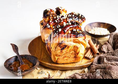 Babka oder Brioche Brot mit Aprikosenmarmelade und Nüssen. Hausgemachtes Gebäck zum Frühstück. Konkreter Hintergrund. Selektiver Fokus. Stockfoto