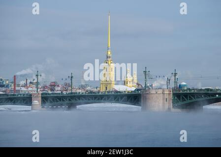 Palastbrücke und Peter und Paul Kathedrale auf dem Winter Neva Fluss an einem frostigen Tag. Sankt Petersburg, Russland Stockfoto