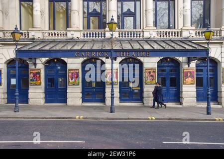 Ein Paar geht am geschlossenen Garrick Theater im West End während der dritten nationalen Coronavirus-Sperre vorbei. London, Großbritannien, März 2021. Stockfoto