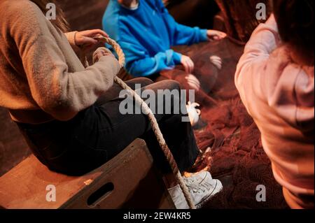 Junge Frauen mit Seil und Reparatur eines Fischernetzes Stockfoto