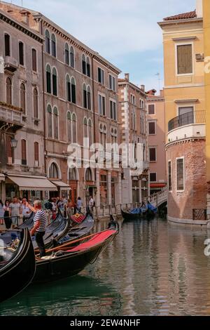 Bacino Orseolo - Gondoliere und Touristen in Gondolas in einem schönen kleinen Kanal mit traditionellen venezianischen bunten Haus - Venedig, Venetien, Italien Stockfoto