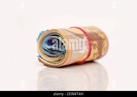 Rolle von vielen Euro-Geld und Bogen isoliert auf weißem Hintergrund. Stockfoto