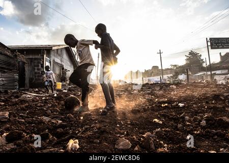 Nairobi, Kenia. März 2021, 01st. Kinder spielen bei der Zwangsräumung von Bewohnern in den Slums von Kibera auf der Straße.einer der größten Slums Afrikas sieht sich derzeit wegen der Zwangsräumungen über den laufenden Bau von Straßen und Eisenbahnlinien durch die Gov't mit der Absicht, den Verkehr in Nairobi zu lindern, mit Tuffzeiten konfrontiert. Kibera Slum ist die Heimat von mehr als 1,5 Millionen kenianischen Bürgern. Kredit: SOPA Images Limited/Alamy Live Nachrichten Stockfoto