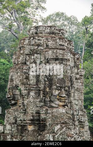 Über 200 riesige Buddha-Gesichter sind in die Türme des Bayon, dem rätselhaftesten Gebäude in Angkor Thom, Kambodscha, eingemeißelt. Stockfoto