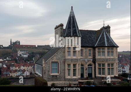 WHITBY, NORTH YORKSHIRE, UK - 18. MÄRZ 2010: BB House namens Streonshalh in Whitby in der West Cliff Area mit Blick auf die Abtei im Hintergrund Stockfoto