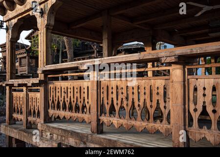 Hölzerne geschnitzte Geländer eines großen alten Holzhauses. Stockfoto