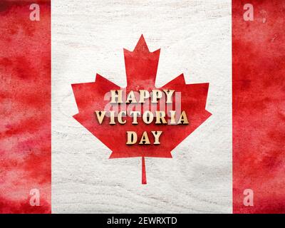 Victoria Day Schriftzug auf dem Hintergrund der kanadischen Flagge. Wunderschöne Karte. Nahaufnahme, Blick von oben. Nationales Urlaubskonzept. Herzlichen Glückwunsch für Stockfoto