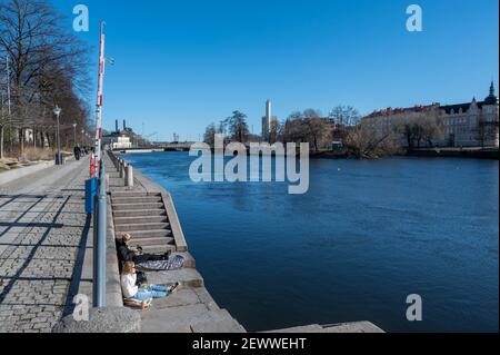 Die Menschen genießen einen frühen Frühlingstag in Norrköping Waterfront Saltängen Ende Februar 2021. Norrkoping ist eine historische Industriestadt in Schweden. Stockfoto
