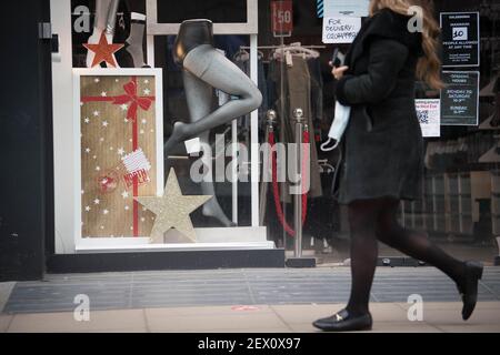 Ein Fußgänger kommt an einem Geschäft in der Oxford Street in London vorbei, das im März 2021 Weihnachtsdekorationen zeigt, nachdem er am 20. Dezember letzten Jahres plötzlich schließen musste, als die Regierung eine weitere Sperrung aufgrund der zunehmenden Verbreitung von Covid-19 ankündigte. Bilddatum: Dienstag, 2. März 2021. Stockfoto