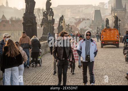 Prag, Tschechische Republik. 03-02-2021. Zwei männliche Freunde laufen, reden und haben viel Spaß auf der Karlsbrücke im Stadtzentrum von Prag durin Stockfoto