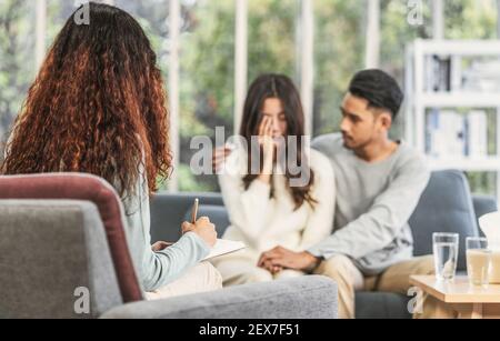 Psychologe Paar Konzept, Closeup Reaw Blick auf Trainer hören und schreiben Notiz über die asiatischen jungen Liebhaber sind Traurigkeit über ihr Problem Stockfoto