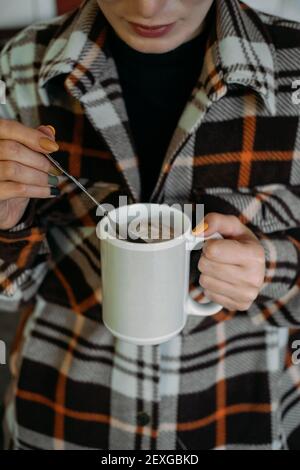 Herbst Winter gemütliche Stimmung Heimtag. Kalter Herbst- oder Wintertag. Wärmende Stimmung. Frau trinkt warmen Kakao mit Marshmallows. Faules Wochenende, Hygge-Konzept Stockfoto