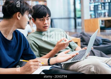 Der Campus junger Studenten hilft Freunden dabei, aufzuholen und zu lernen. Stockfoto