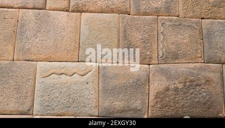 7 Schlangen, die in der Kaiserstadt cusco, Peru, auf einer Steinmauer gemeißelt wurden Stockfoto