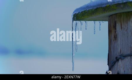 Ein selektiver Fokus von Eiszapfen, die vom Dach hängen Stockfoto