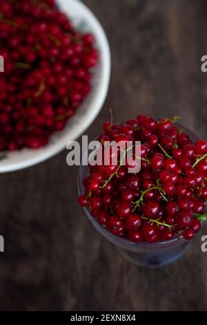 Johannisbeeren in einer Schüssel auf schwarzem Hintergrund. Rote Beere. Vitamin-Beeren. Speicherplatz kopieren. Stockfoto