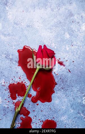 Rote Rosen und Blut auf einem blauen texturierten Hintergrund mit Platz für Text und Text Stockfoto