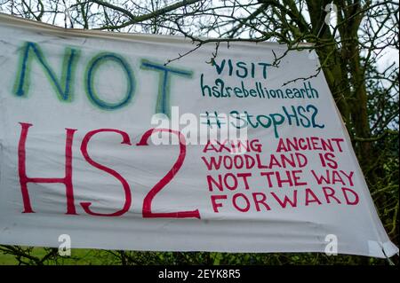 Great Missenden, Buckinghamshire, Großbritannien. März 2021, 4th. Ein Anti HS2 Banner in den Bäumen. HS2 Ltd haben 14 majestätische Eichen markiert, die entlang der Leather Lane in Great Missenden zum Fällen bereit sind. Anwohner haben eine Petition zur Rettung von Leather Lane Oaks gestartet. Ein neues Stop HS2 Protestcamp wurde eingerichtet, um die majestätischen Eichen bis HS2 vor der drohenden Zerstörung zu schützen. Die umstrittene High Speed 2 Bahnverbindung von London nach Birmingham ist eine riesige Narbe über die Chilterns, ein Gebiet von außergewöhnlicher natürlicher Schönheit, die viel Aufregung für Einheimische und Baumliebhaber verursacht. Quelle: Maureen McLean/Alamy Stockfoto