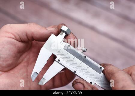 Messen des Durchmessers des Schraubengewindes mit einem Bremssattel. Stockfoto