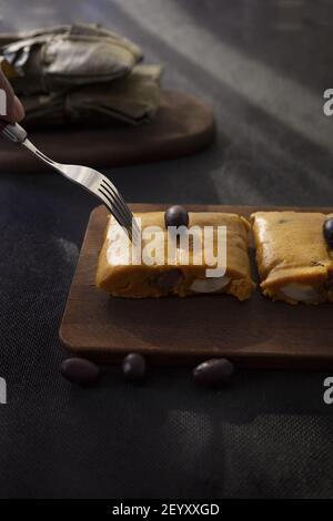 Typisches Gericht von Peru unter dem Namen Tamales bekannt, mit Maismehl, Huhn oder Schweinefleisch, Knoblauch, Chili, schwarzen Oliven und Ei gemacht. Stockfoto