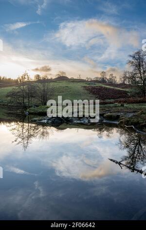 Am frühen Morgen ungewöhnliche Wolkenspiegelung in Tarn Hows in der Nähe von Hawkshead Stockfoto