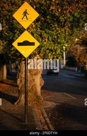 Überqueren Fußgänger Menschen Straßenschild in großen Sonnenuntergang Licht in einer ruhigen Nachbarschaft Straße in Killarney, County Kerry, Irland. Stockfoto