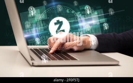Business Hand arbeiten an der Börse mit zcash Symbole kommen Aus dem Laptop-Bildschirm Stockfoto