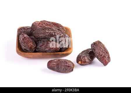 HURMA, Termine. Getrocknete Datteln Obst mit Holzplatte auf weißem Hintergrund. Beliebte Frucht des Ramadan. Stockfoto