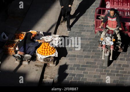 Eine lokale Frau, die Orangen am Straßenrand in der Nähe von Zuwayla Gate, Kairo, Ägypten verkauft Stockfoto