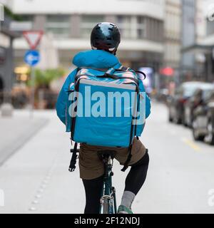 Kurier Auf Dem Fahrrad Liefert Essen In Der Stadt. Stockfoto
