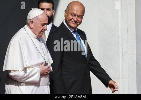 Bagdad, Irak. März 2021, 08th. Der irakische Präsident Barham Saleh (R) begleitet Papst Franziskus (L) während seiner Abschiedserzeremonie auf dem internationalen Flughafen Bagdad zum Abschluss seines viertägigen Besuchs im Irak. Quelle: Ameer Al Mohammedaw/dpa/Alamy Live News Stockfoto
