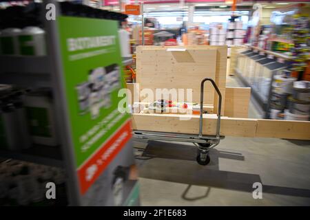 Dresden, Deutschland. März 2021, 08th. Ein Kunde schiebt einen beladenen Warenkorb in einem Hornbach-Baumarkt durch einen Gang. Ab heute dürfen Baumärkte in Sachsen nach wochenlanger Schließung aufgrund von Korona den Betrieb nach strengen Hygienevorschriften wieder aufnehmen. Quelle: Robert Michael/dpa-Zentralbild/dpa/Alamy Live News Stockfoto