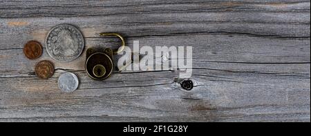 Vintage Sammlung von Münzen und antiken Schloss auf verwitterten Holz Plank Stockfoto