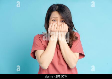 Die schöne asiatische Frau bedeckte ihren Mund mit beiden Händen Mit einem verängstigten Gesicht Stockfoto