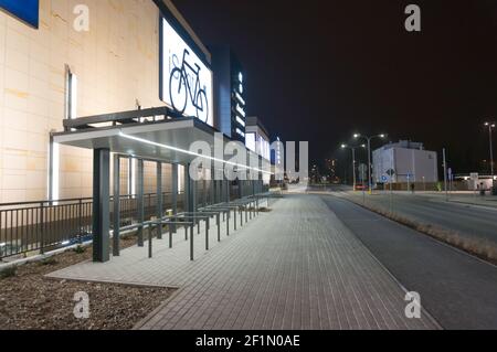 POZNAN, POLEN - 13. Feb 2017: Fahrradständer aus Metall neben dem neuen Einkaufszentrum Posnania bei Nacht Stockfoto