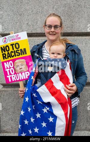 Liz Burlon, ursprünglich aus Boston, lebt heute in London, ist mit dem Baby Santiago (6,5 Monate alt) auf dem Trafalgar Square in London abgebildet, wo am zweiten Tag des Staatsbesuchs von US-Präsident Donald Trump in Großbritannien Proteste stattfinden. Liz sagt: "Ich bin hier, um meinem Sohn ein gutes Beispiel dafür zu geben, was es ist, Amerikaner zu sein - Trump ist böse." Bildnachweis sollte lauten: Katie Collins/EMPICS/Alamy Stockfoto