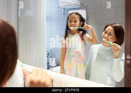 Vietnamesische Mutter und Tochter Zähneputzen zusammen am Morgen Stockfoto