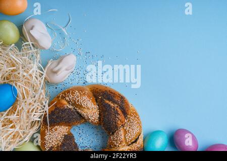 Umweltfreundliches Osterdekor mit natürlichen, wiederverwendbaren, abfallfreien Materialien, handgefertigten gefärbten Eiern, Brotring mit Mohn- und Sesamsamen, Upcyclin Stockfoto