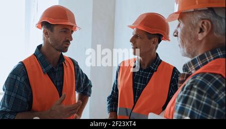 Bauherren in Schutzhelme reden auf der Baustelle Stockfoto