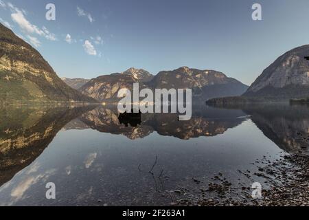 Spiegelreflexion in Hallstatter See, Österreich. Sommer Frühling Farben See und Berg bei Sonnenaufgang in österreichischen Alpen.schöne ruhige Naturlandschaft Stockfoto