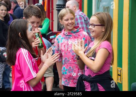 Mädchen spielen Hand klatschen Spiele auf der Auld Lammas Fair, Ballycastle, Moyle, County Antrim, Nordirland, VEREINIGTES KÖNIGREICH Stockfoto