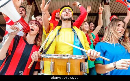 Fußballfans jubeln und sehen Fußballpokal an intenational Stadion Tribüne - Sportkonzept mit Jugendlichen Gruppe Stockfoto