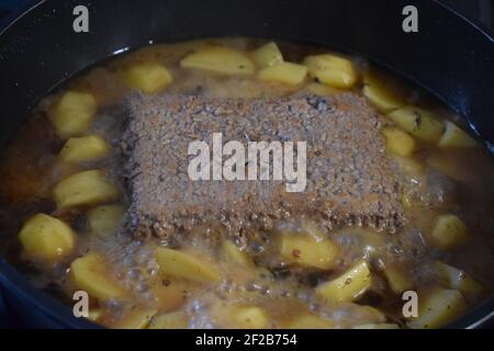 Hackfleisch und Kartoffeln in einer Pfanne braten Stockfoto