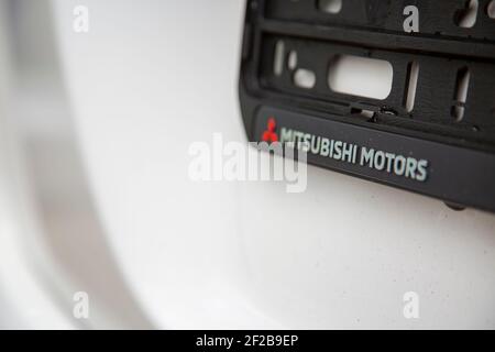 Moskau, Russland: - 30. September 2019: Mitsubishi Motors Logo auf Nummernschildrahmen auf weißem Auto Nahaufnahme, selektiver Fokus Stockfoto